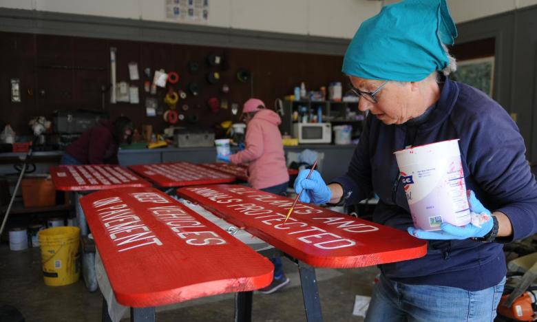 Painting signs at Cane Creek State Park. 
